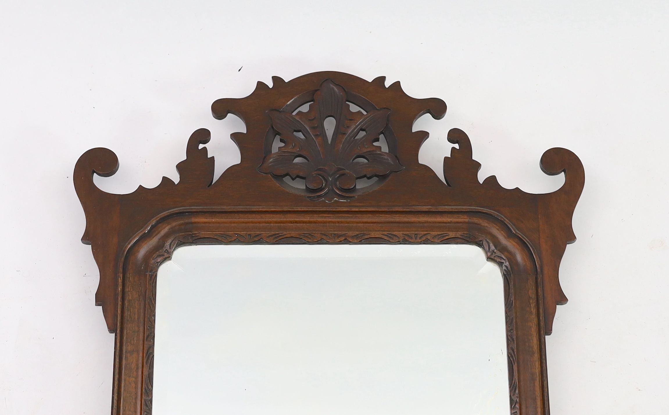 A George III style mahogany fret cut wall mirror, width 50cm height 88cm